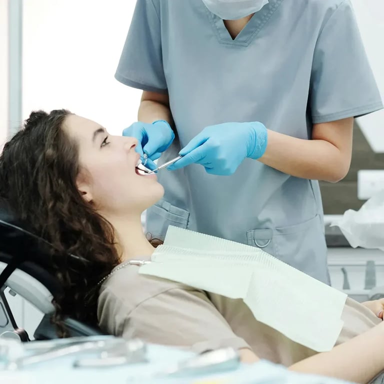 Dentist examining patient in dental chair